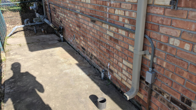 A view of the cleaned up conduit (and a very intrusive shadow) on May 7th, 2020. Leftover and abandoned conduit was removed and cleaned up. Cleaned-up Conduit