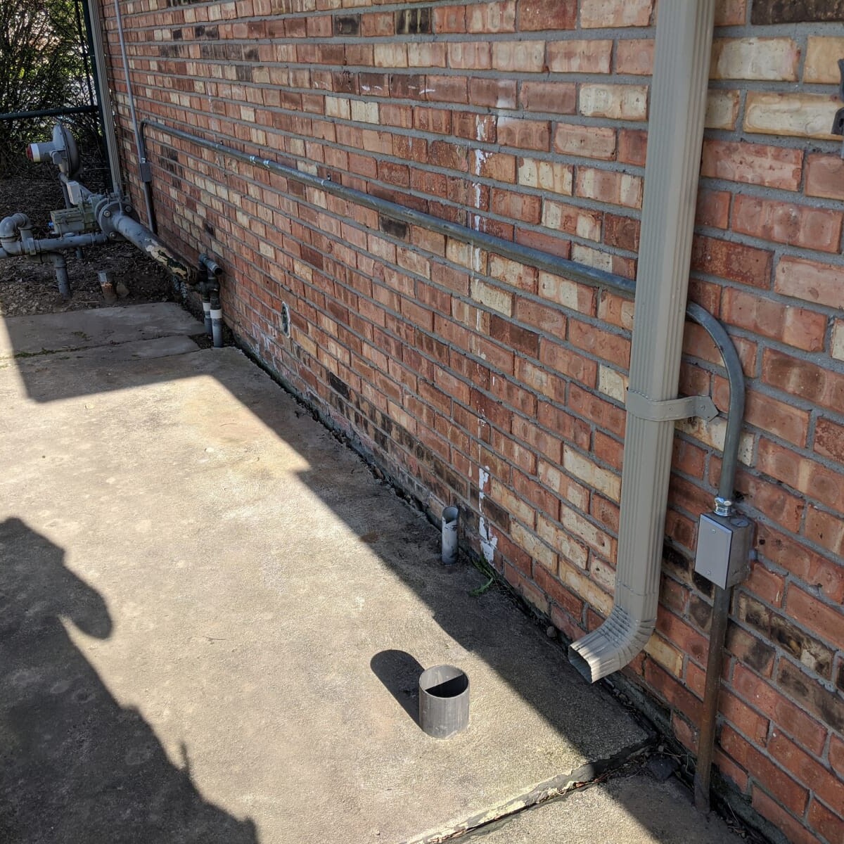 A view of the cleaned up conduit (and a very intrusive shadow) on May 7th, 2020. Leftover and abandoned conduit was removed and cleaned up. Cleaned-up Conduit