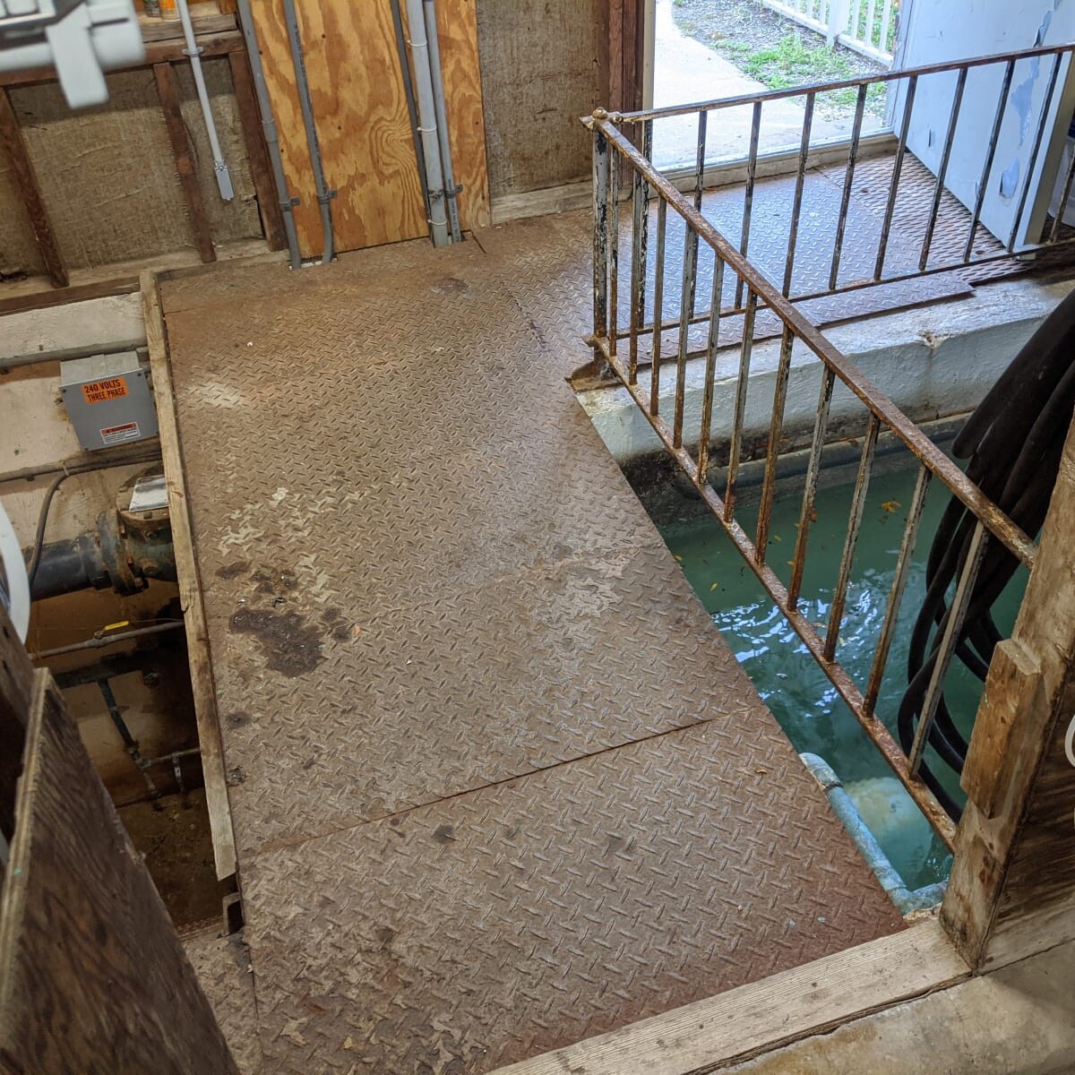 An alternate view of the old floor, surge tank and surge tank railing on July 20th, 2020. Old Floor and Surge Tank