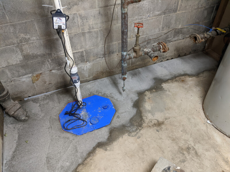 The new sump pump. At this point in the project - there was a slight issue. Both clean-outs (sanitary and foundain drain trap) were covered! This was later corrected after two follow-up visits by FSM. New Sump Pump in January 2021