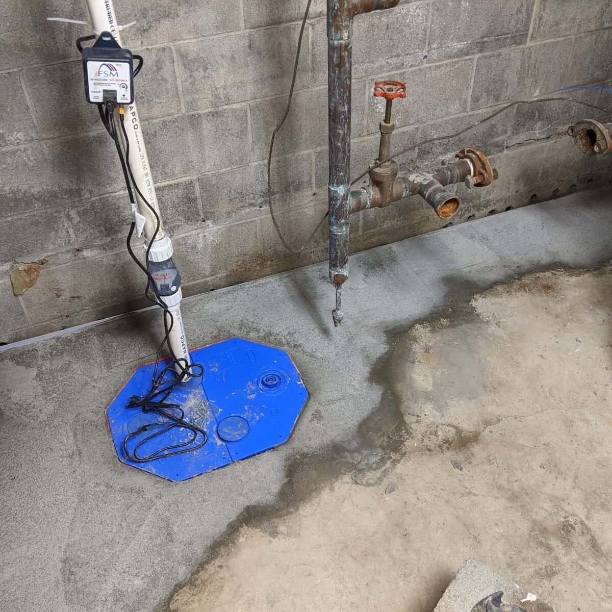 The new sump pump. At this point in the project - there was a slight issue. Both clean-outs (sanitary and foundain drain trap) were covered! This was later corrected after two follow-up visits by FSM. New Sump Pump in January 2021