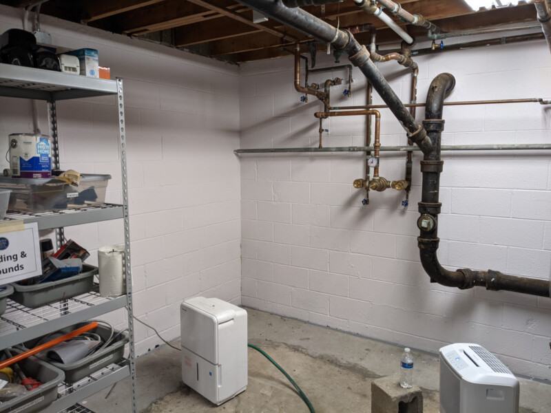 The northwest basement corner, shortly after painting was completed. Also visible - the new tempering valve (from 2020) and plumbing repairs made by Rob Olenzik (in 2021). Not shown: the final basement clean-up (including a re-organized Building & Grounds storage shelf!) Northwest Basement Corner in May 2021