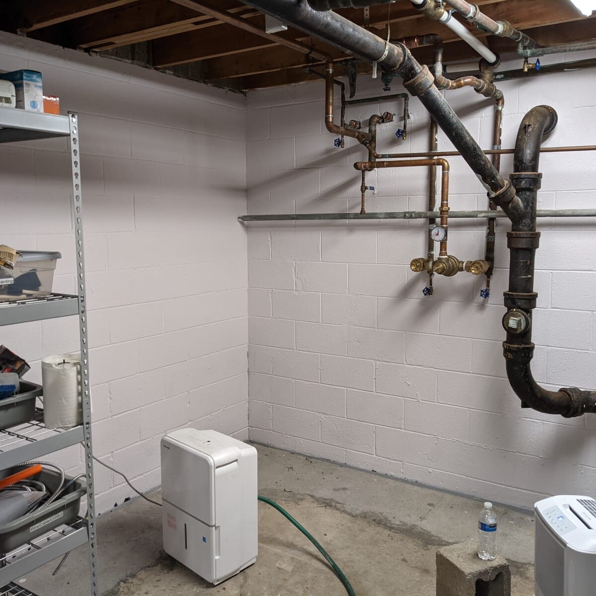 The northwest basement corner, shortly after painting was completed. Also visible - the new tempering valve (from 2020) and plumbing repairs made by Rob Olenzik (in 2021). Not shown: the final basement clean-up (including a re-organized Building & Grounds storage shelf!) Northwest Basement Corner in May 2021