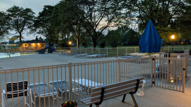 A view of the pool deck at night on May 24th, 2021. The new pump house soffit lights (and a recently painted bench) are also visible in the photo. Pool Deck at Night in May (7 of 7)