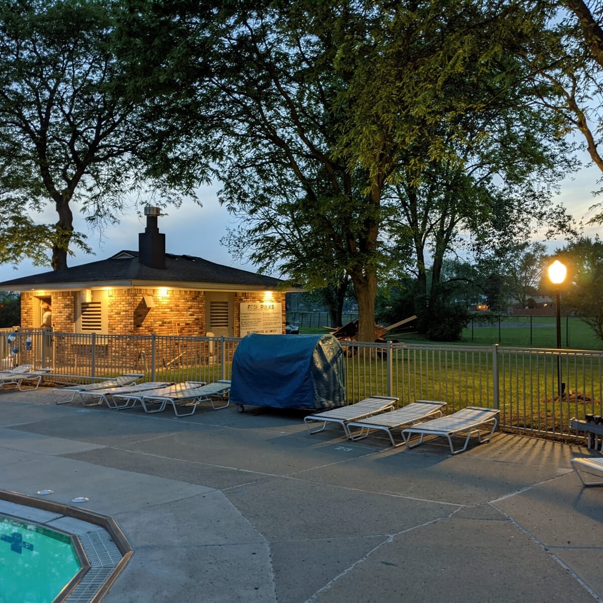 A view of the pool deck at night on May 24th, 2021. The new pump house soffit lights are also visible in the photo. Pool Deck at Night in May (6 of 7)