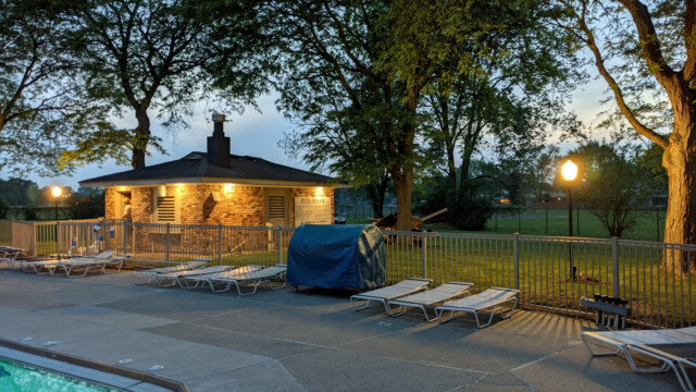 A view of the pool deck at night on May 24th, 2021. The new pump house soffit lights are also visible in the photo. Pool Deck at Night in May (6 of 7)
