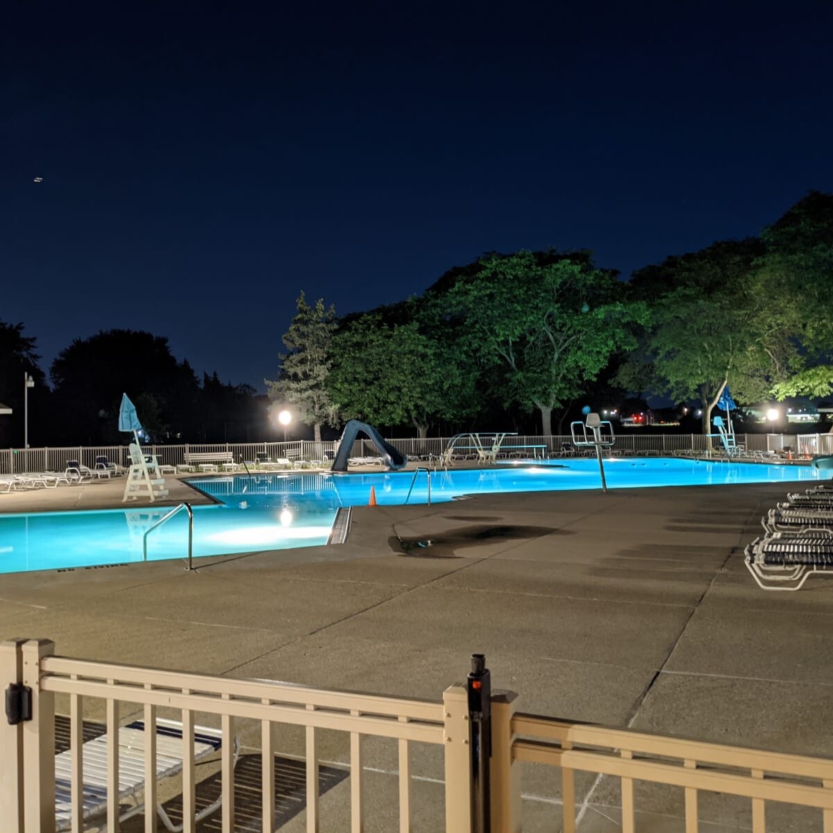 A view of the pool deck at night on June 10th, 2021. The new pump house soffit lights are also visible in the photo. Pool Deck at Night in June (2 of 2)