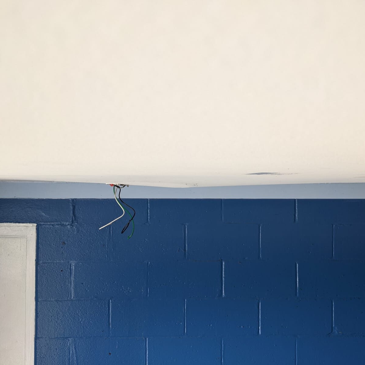 A view of the sagging ceiling. We suspect that the weight of the fixture (mounted by toggle bolt) along with humidity and time resulted in the sagging of the ceiling. B&G was able to repair this section of drywall without replacement. Photo taken on March 9th, 2022. Sagging Ceiling, View #1