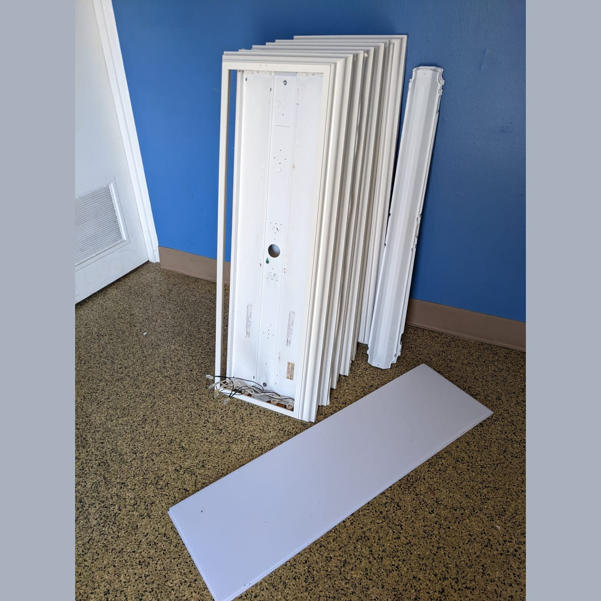 The prior surface-mount light fixtures after removal. Photo taken on March 9th, 2022. Old Lights