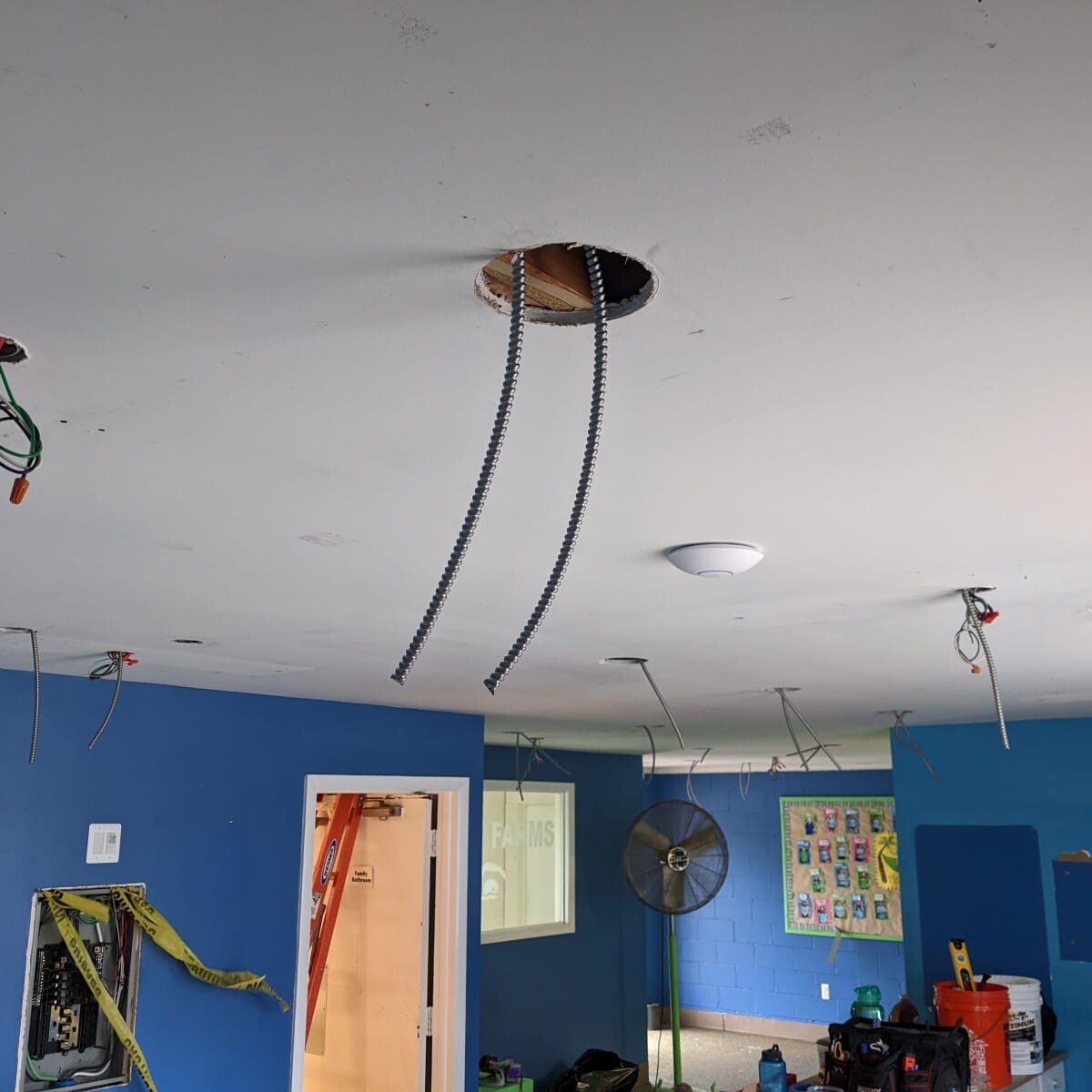 A view of the lighting installation in progress, as taken on March 19th, 2022. Note the prior lobby colors and lack of refreshed ceiling paint. Lighting Wiring Installation in Progress #1