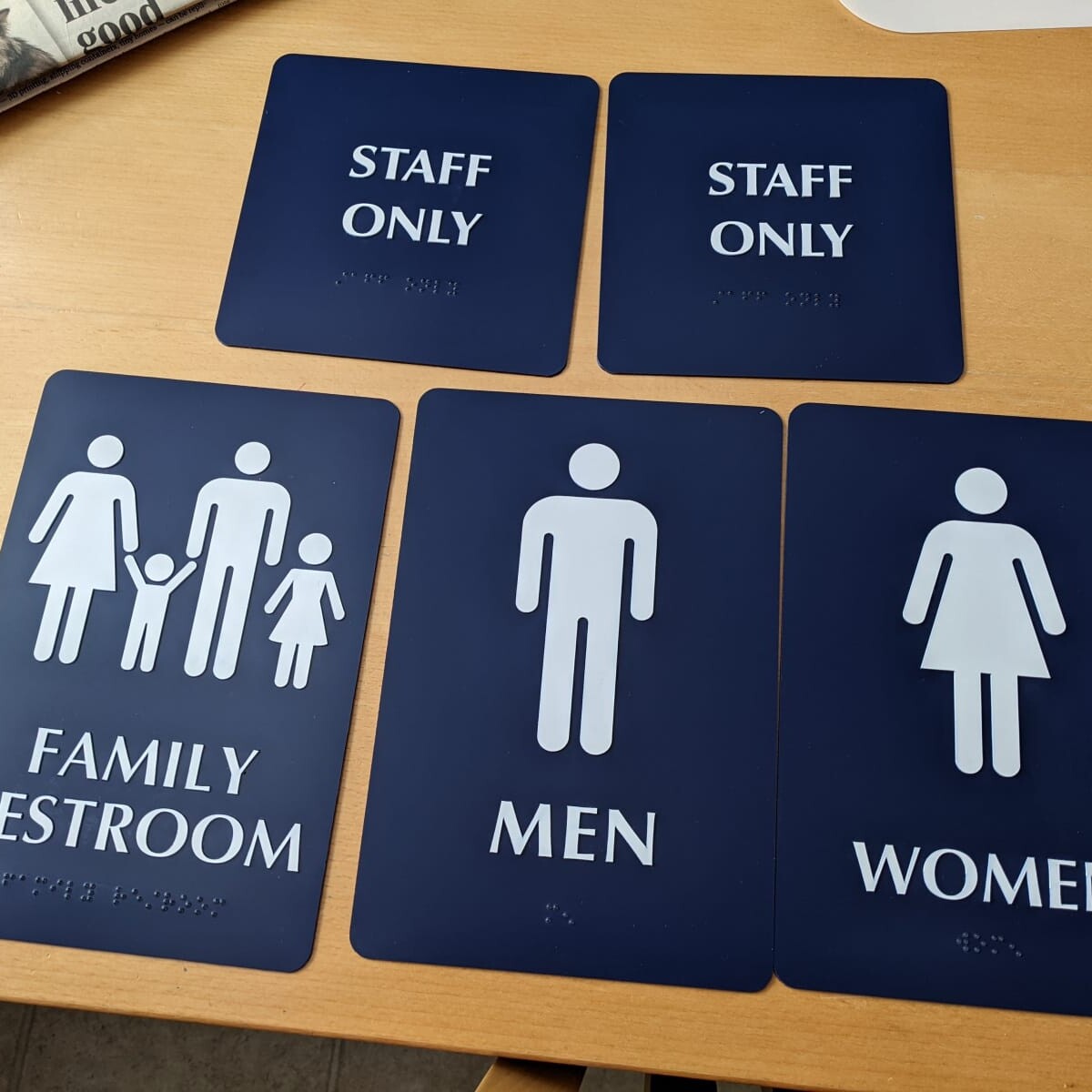 The new door signs for the restrooms, Snack Shack, and basement. Photo taken on May 1st, 2022. New Door Signs