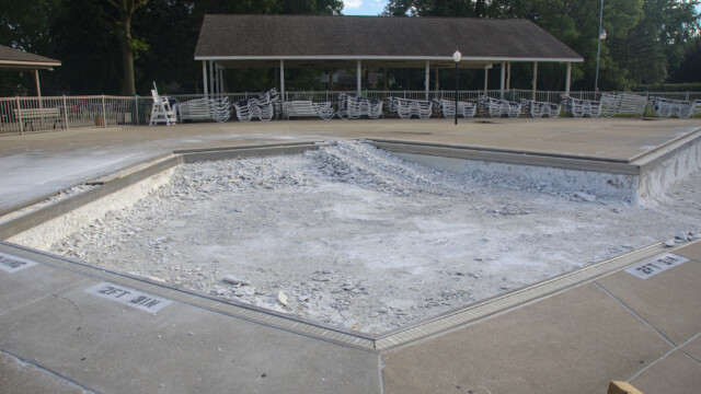 A stack of debris in the "baby pool". The technique here was later changed (per repeated requests by B&G) to avoid damage to the gutter tray and grates from marcite debris. This ramp was used for the small loader to drive into and out of the pool. Demolition - Day 6