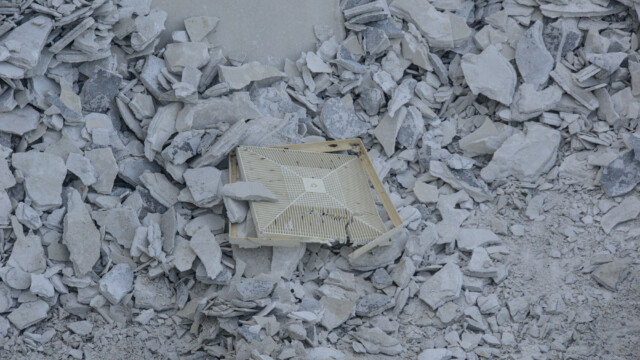 One of the floor drain covers in a pile of debris. Demolition - Day 6